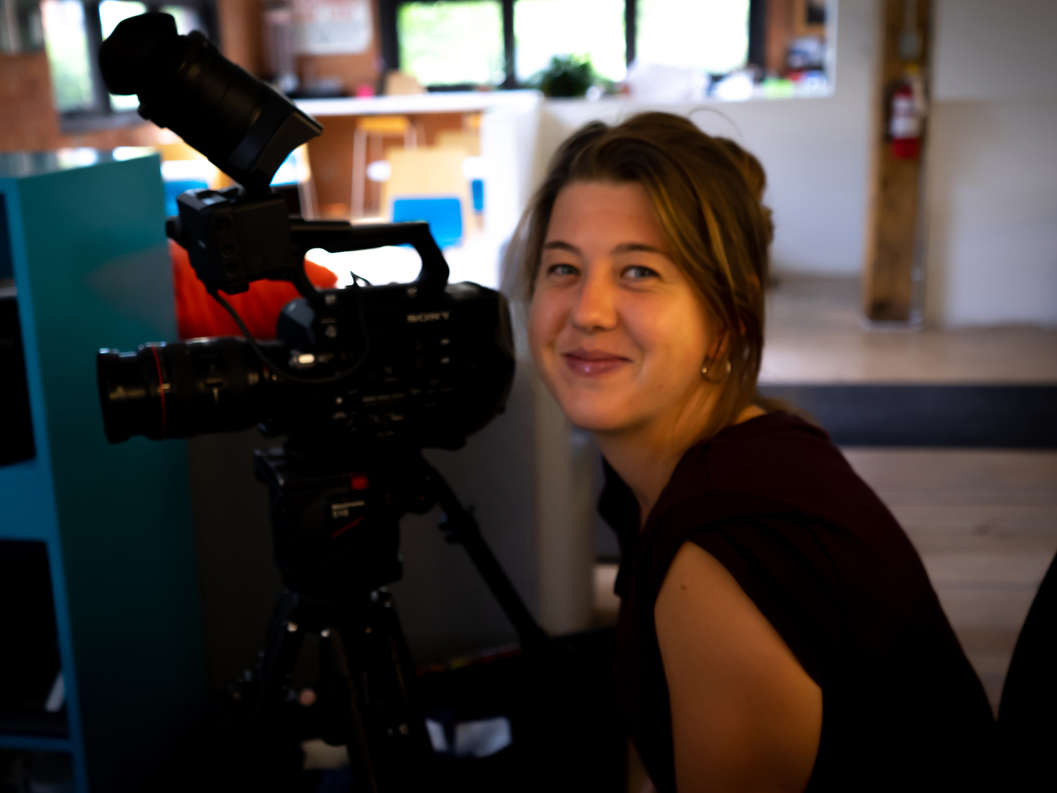 Head shot of Lindsay Fitsgerald with a camera. 