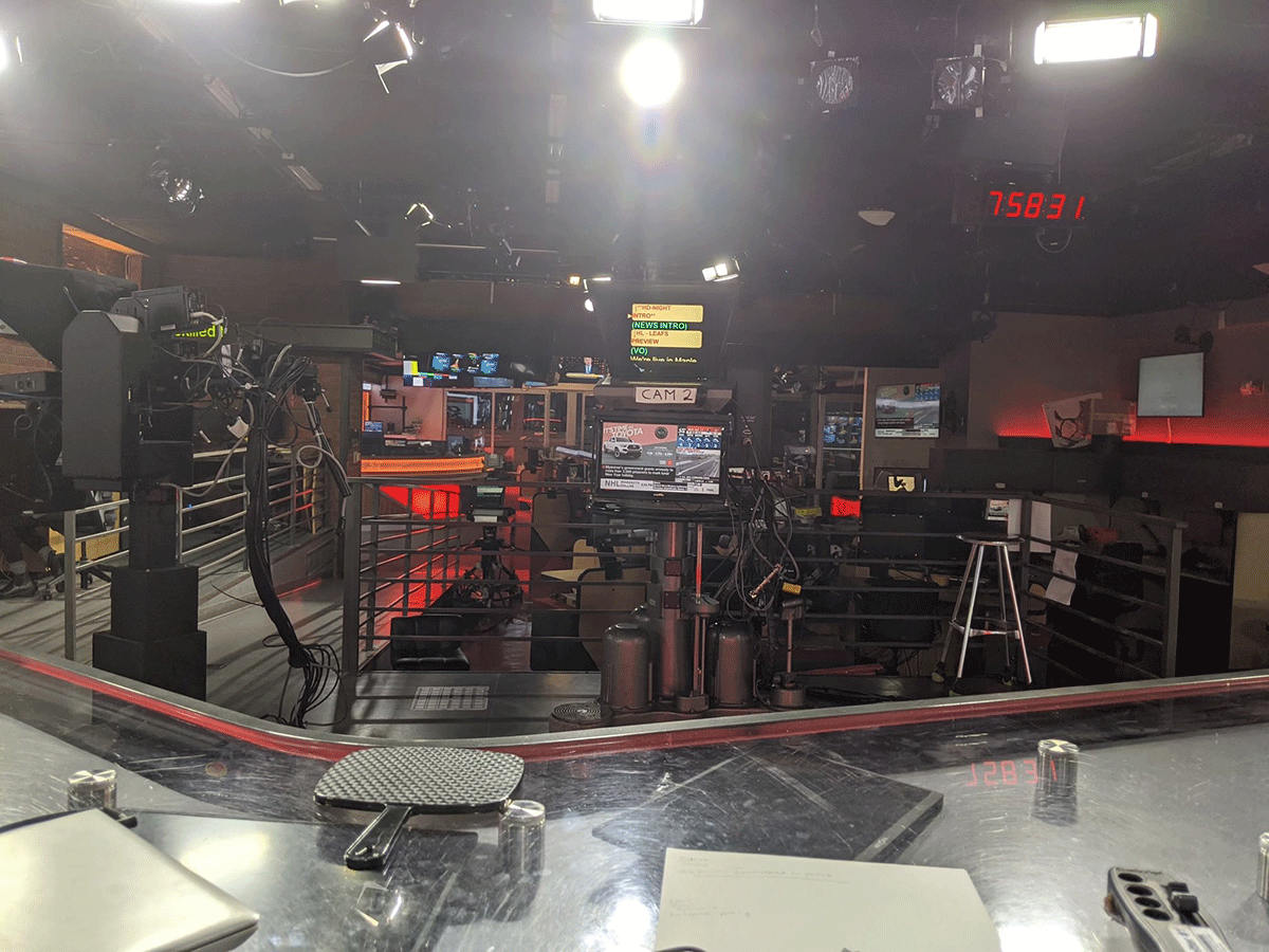 The CP24 news room showing a desk, multiple cameras and monitors
