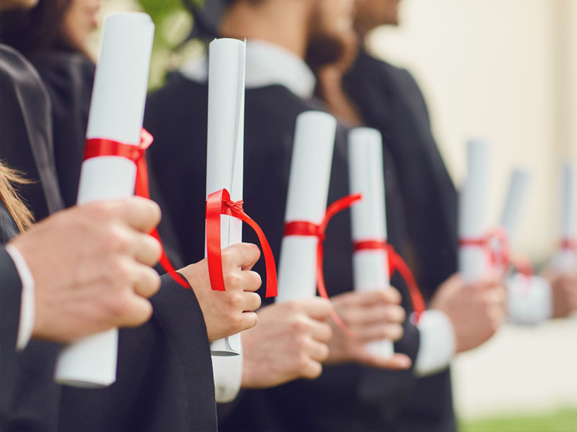 Graduates holding diplomas