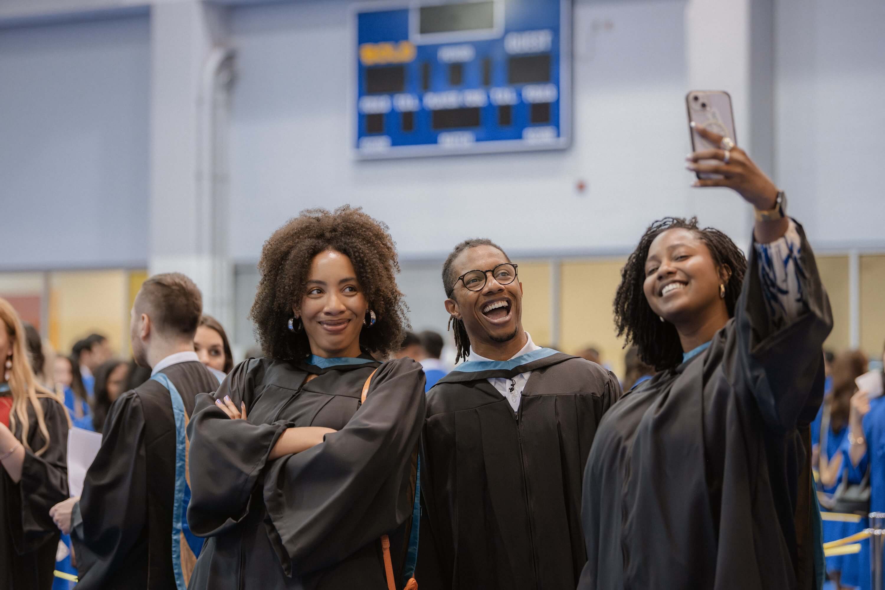 Three graduates posing for a selfie at Convocation.