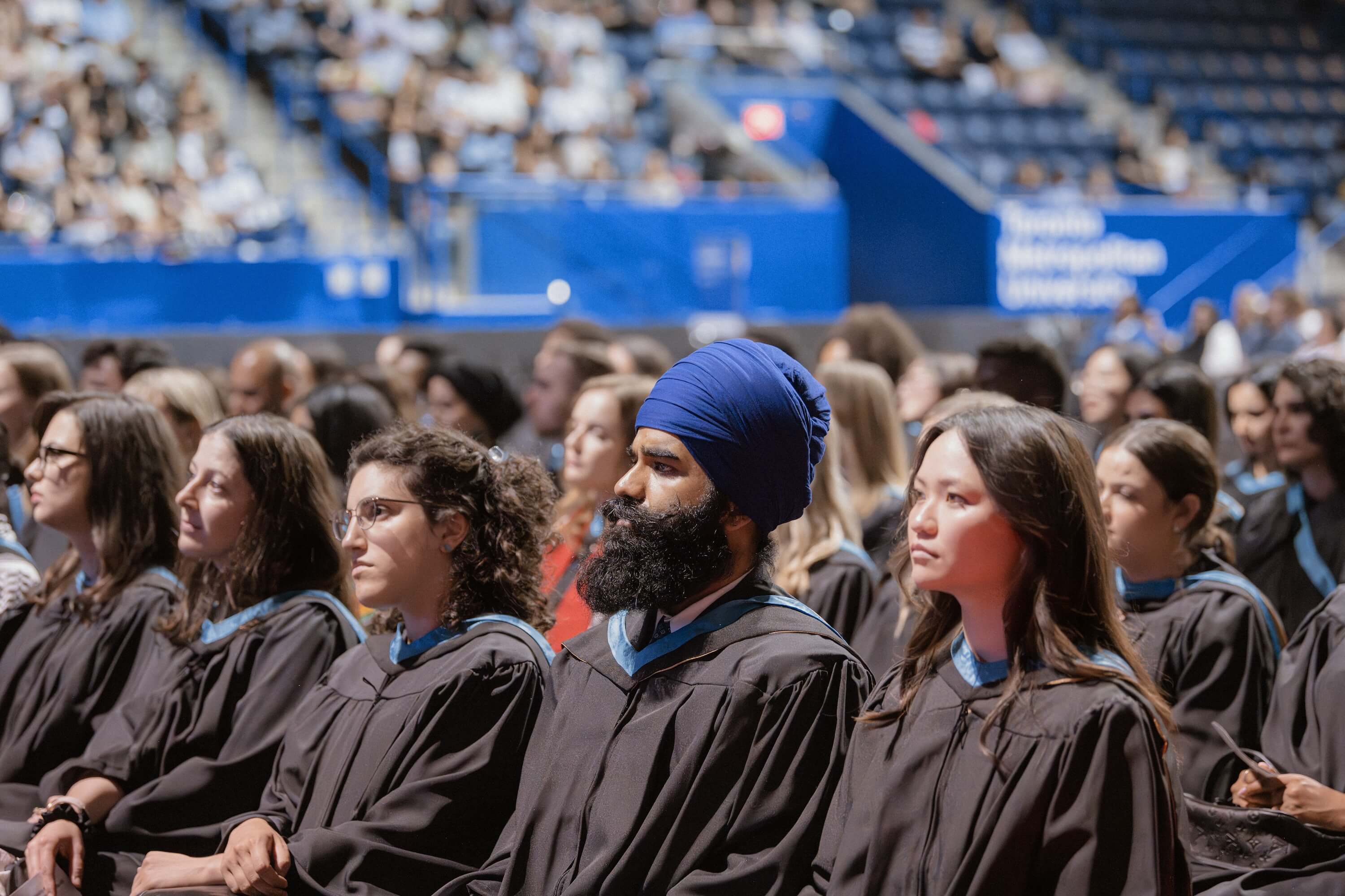 Graduates sitting in the audience at Convocation.