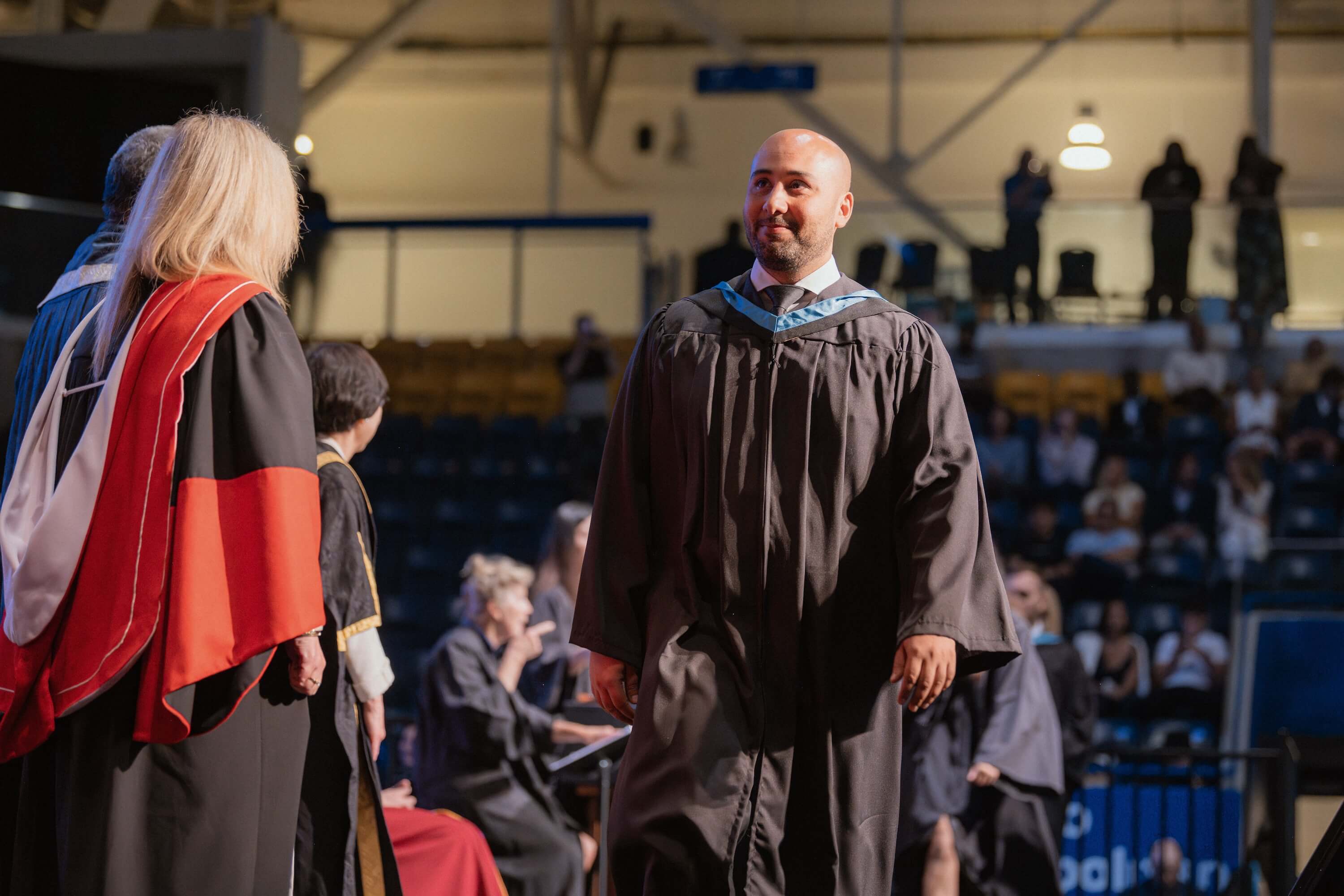 A man walking across the stage at Convocation.