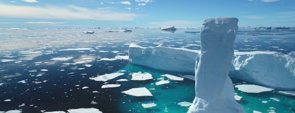 Icebergs floating in the Arctic Ocean on a sunny day.