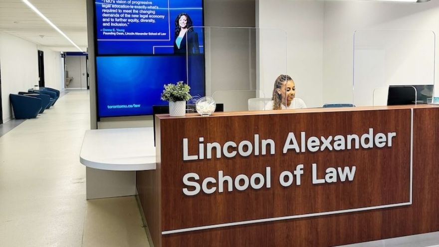 The reception desk at Lincoln Alexander Law with a young woman sitting behind the desk.