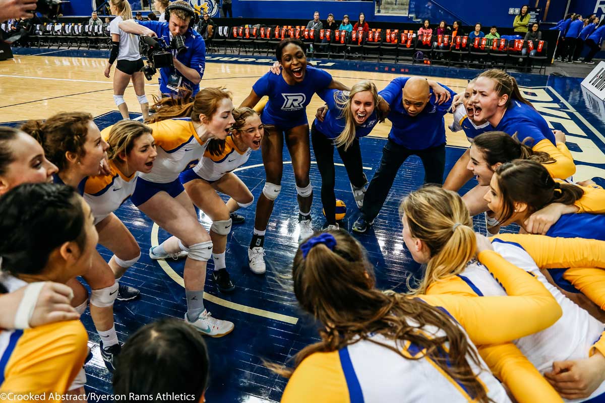 Women's volleyball team in a huddle