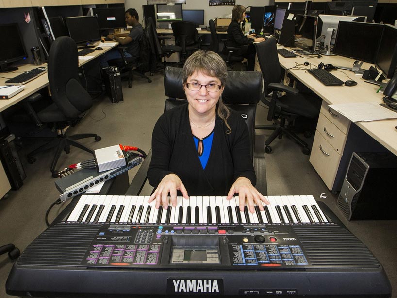 Deb Fels plays on a keyboard