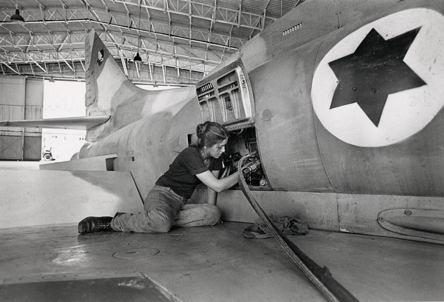 Woman fixing plane engine