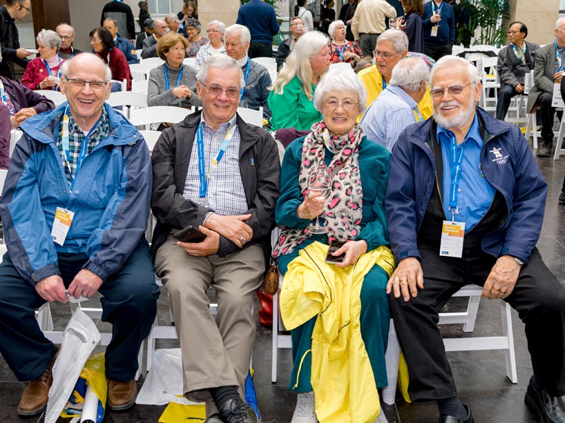 Four alumni sitting in chairs