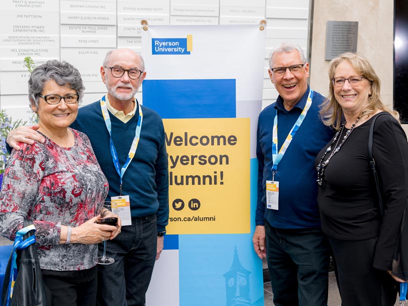 Two pairs of couples flanking a sign