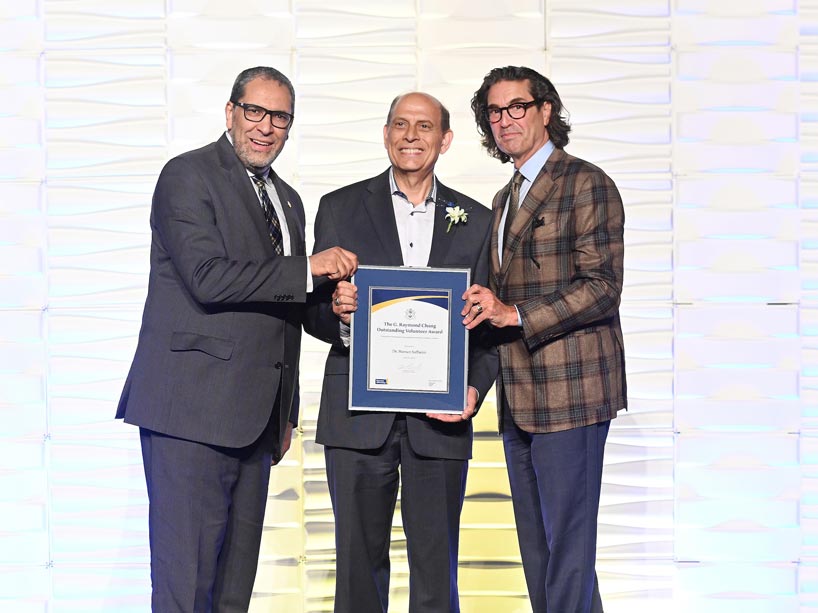 2.	Volunteer in civil engineering, Hassan Saffarini, centre, with President Mohamed Lachemi (left) and Ian Mishkel, vice-president, university advancement and alumni relations.