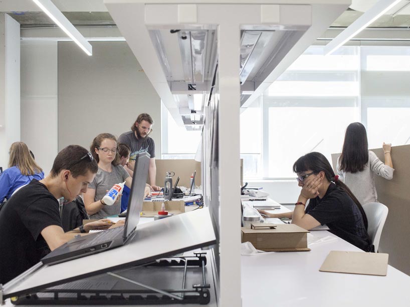 A group of students work on varying tasks in an Architectural Science studio classroom