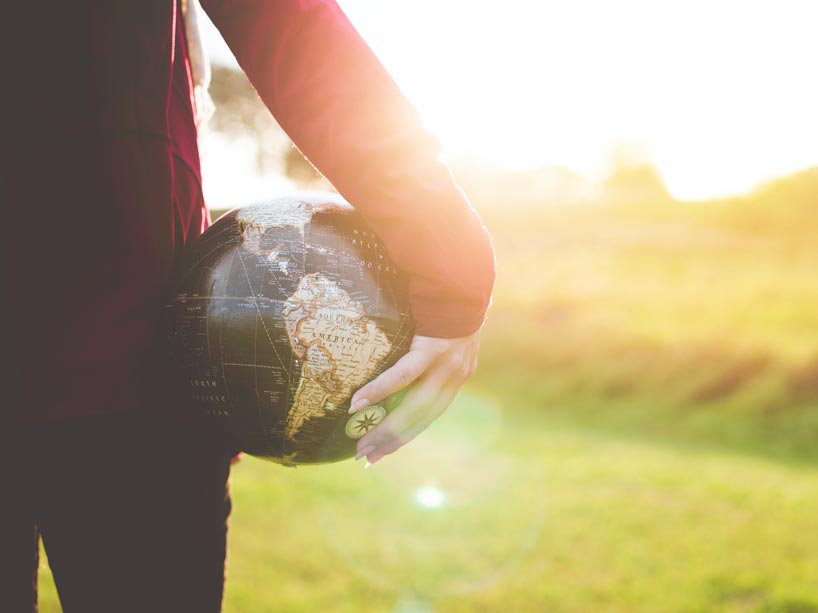 A person holding a globe