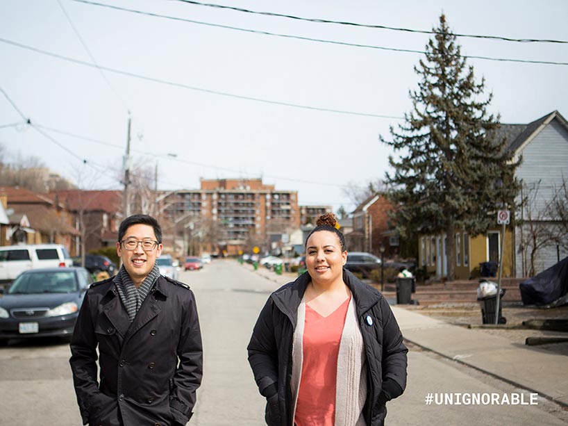 Two people standing in the middle of the road 