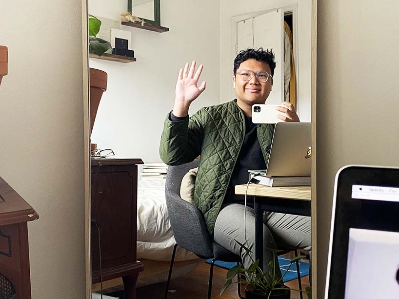 Kyle Jarencio takes a ‘selfie’ while sitting at the desk in his room.