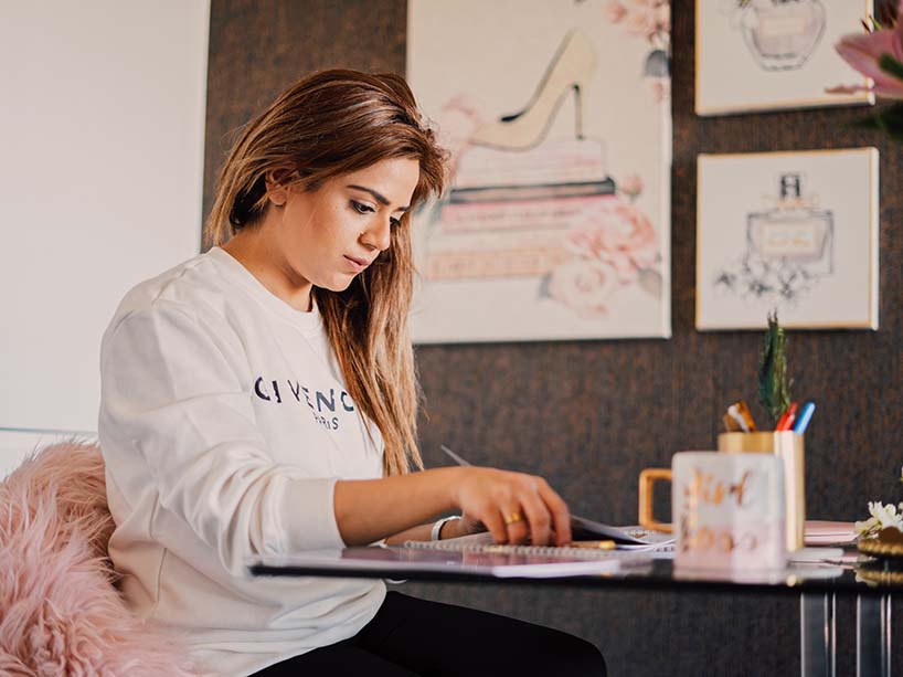 Zahra Khan working at a table.