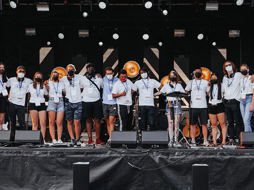 Graham Beer on stage with volunteers. 