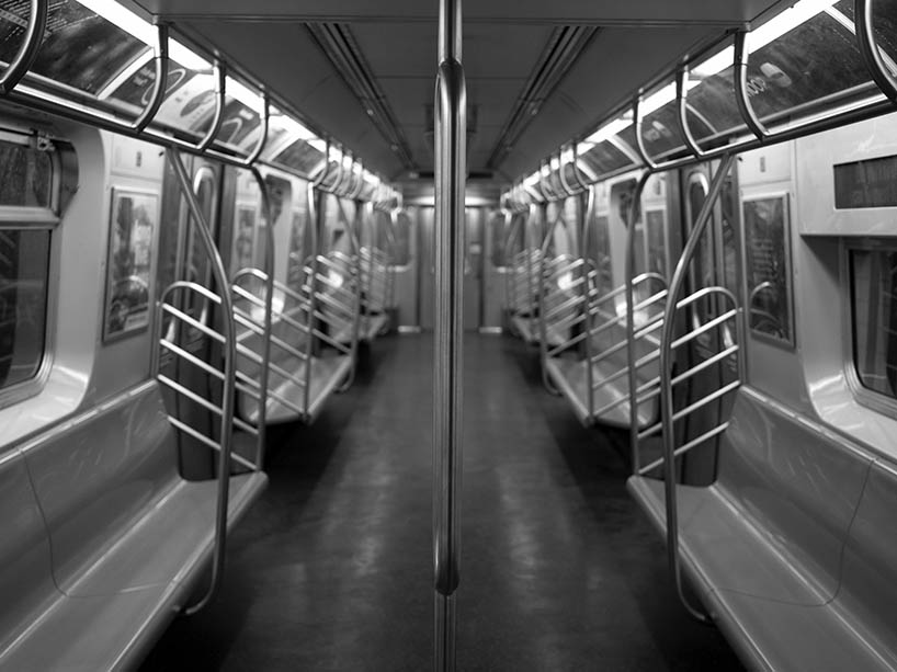 A black and white photo of an empty subway car.