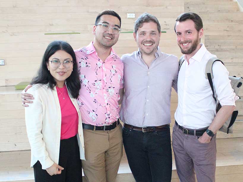 A group of four smile for the camera. 