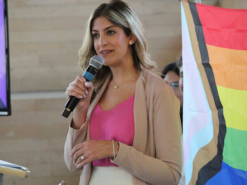 Nika Zolfaghari speaking at a podium.