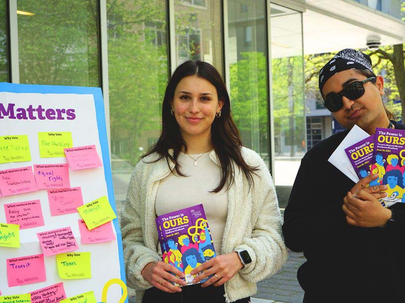 Students holding voting booklets.