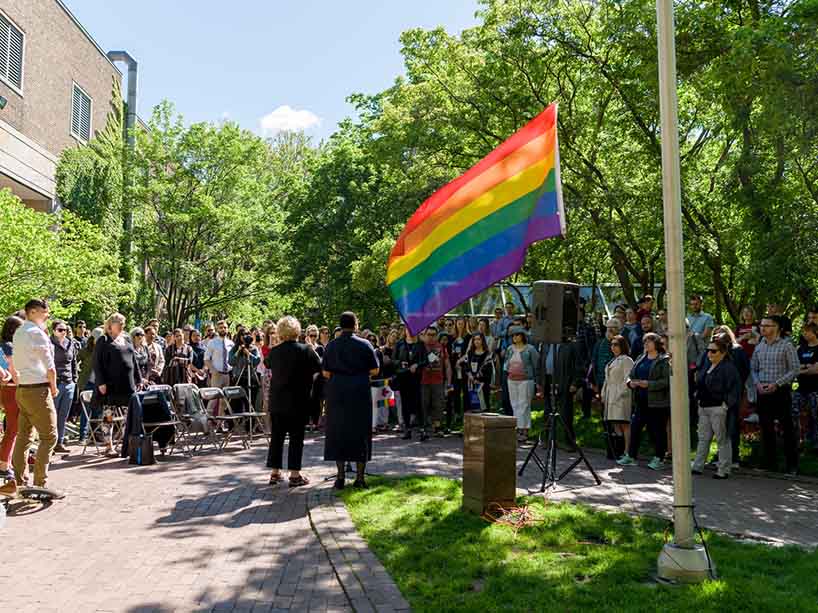 The TMU community gathers for a Pride flag raising ceremony. 