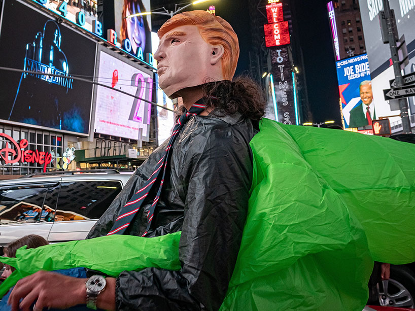 Person wearing a Donald Trump mask in Times Square.