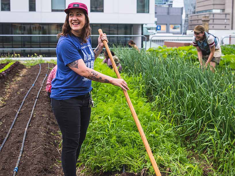 Operations coordinator, Jess Russell, hoeing the field on the ENG rooftop farm. 