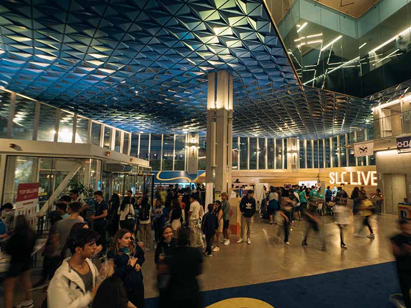 Students walking around the first floor of the Student Learning Centre. 