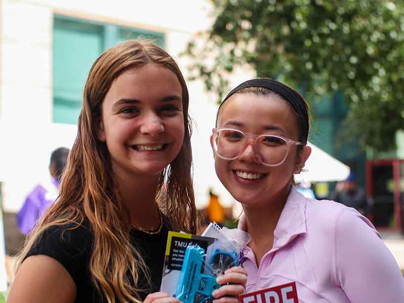 Two students standing at Pitman Hall Residence. 