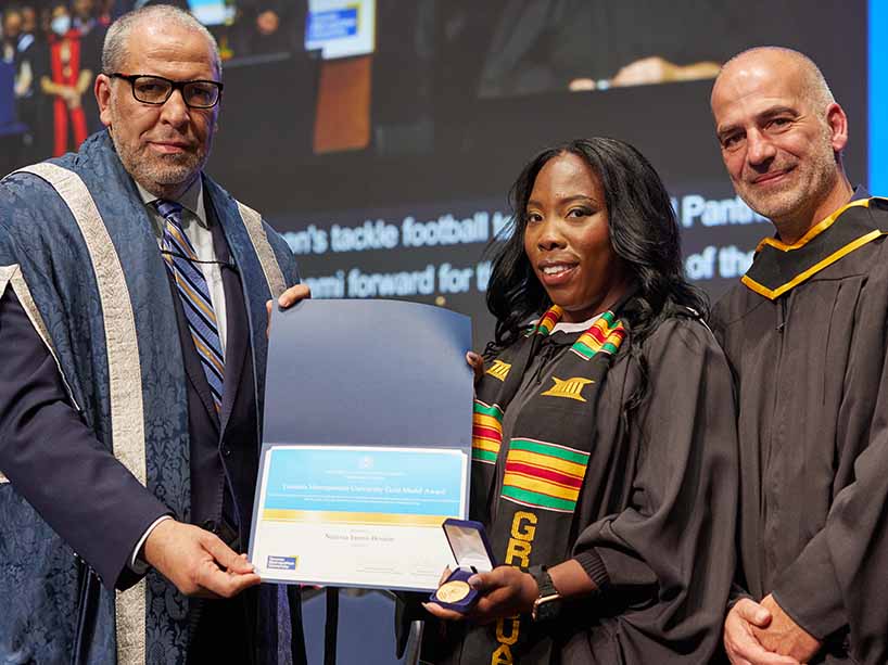 Master’s of Child and Youth Care graduate Nerissa Inniss-Boston, centre, receives her degree and Gold Medal award from TMU President Mohamed Lachemi, left, and Kiaras Gharabaghi, Dean, Faculty of Community Services and Professor, School of Child and Youth Care, at right.