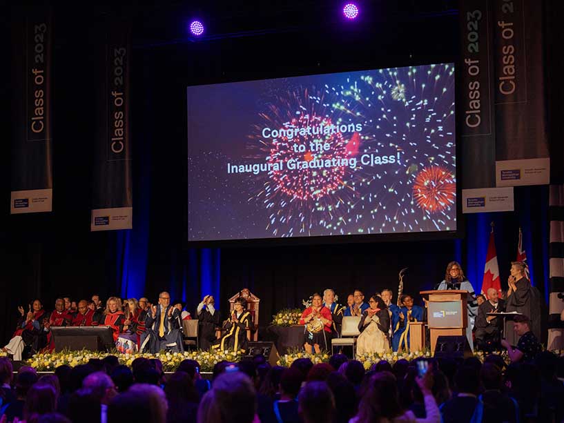 A group of people on the stage for Convocation.