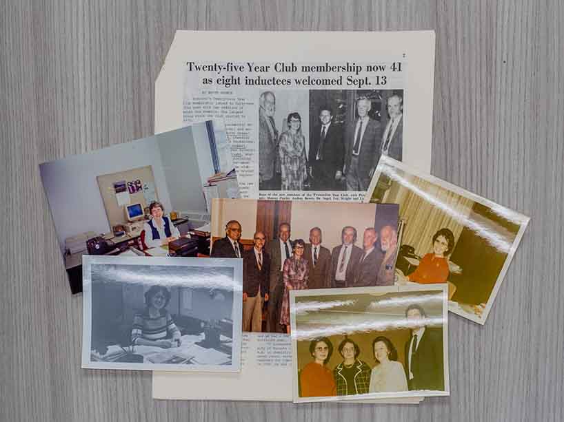 A selection of photos of Audrey Bowes laid out on a table.