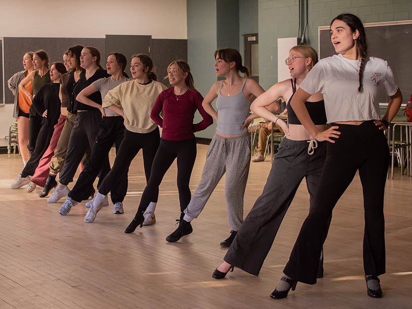 A group of students rehearsing a dance number together. 