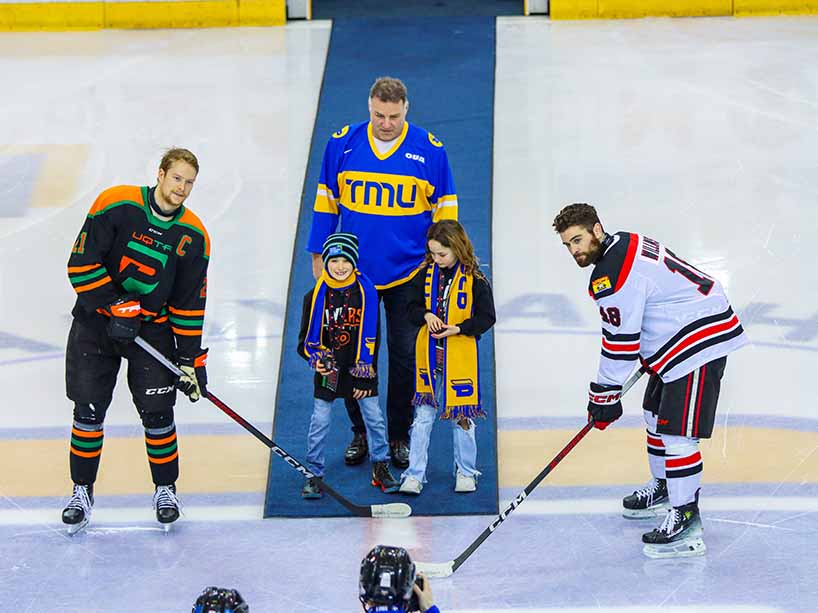 Former NHL star Eric Lindros performs a ceremonial puck drop at the championship game of the tournament. He’s joined by his children and the captains of the two teams.