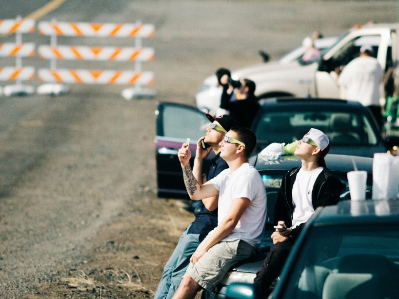 A group of friends with special glasses on view an eclipse together in  2017. 