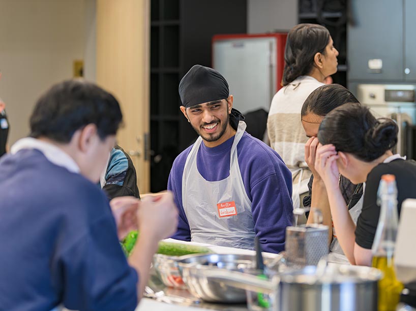 A student laughs while chatting with friends