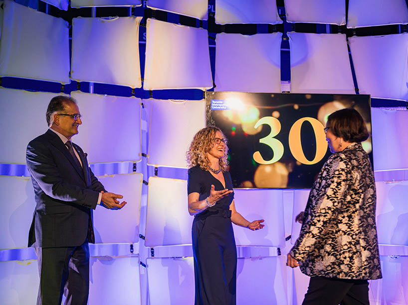 Saeed Zolfaghari claps as Jenny O’Donnell congratulates Monica McKay with a hug.