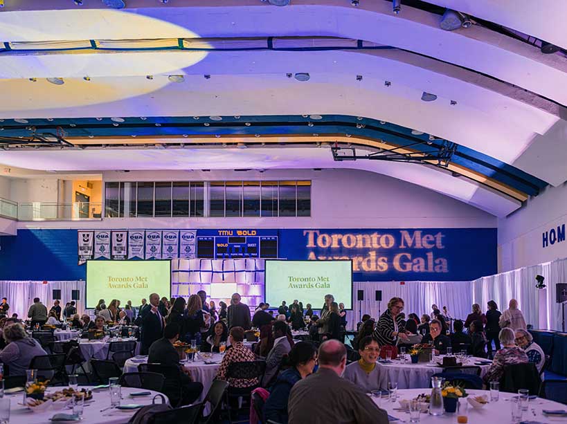 A crowd of people milling about with a sign above that reads ‘Toronto Met Awards Gala’