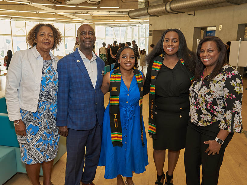 Ashley-Ann Malcolm with her parents, and another graduate with her mother.