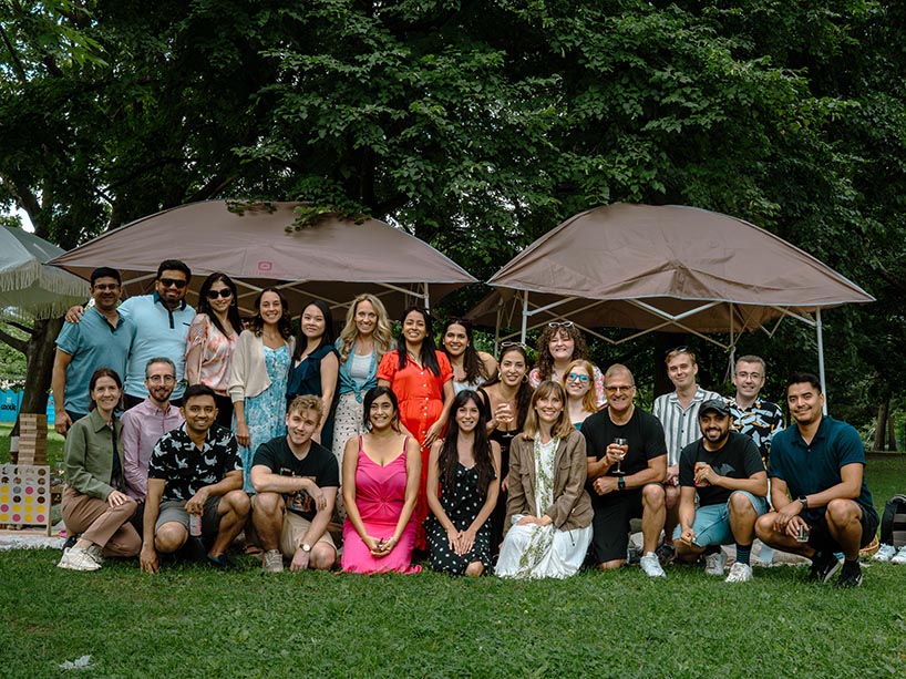 A group of people pose for a photo at a picnic.