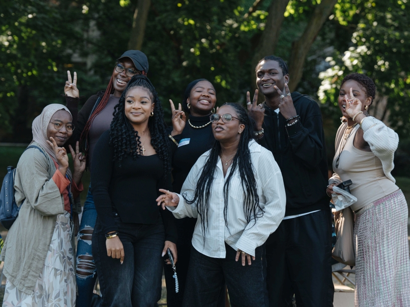 A group of Black students pose for a photo in the TMU quad. 