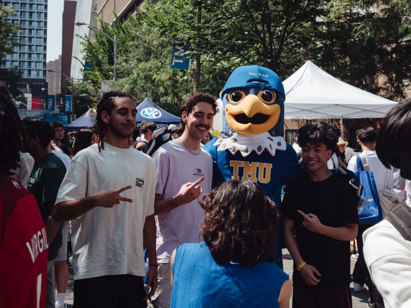 Students pose for a photo with TMU mascot Frankie B. Bold during a festival on Gould Street.