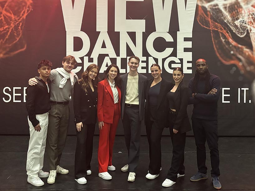 Josh Hoven and his colleagues from the VIEW Dance Challenge pose on set.