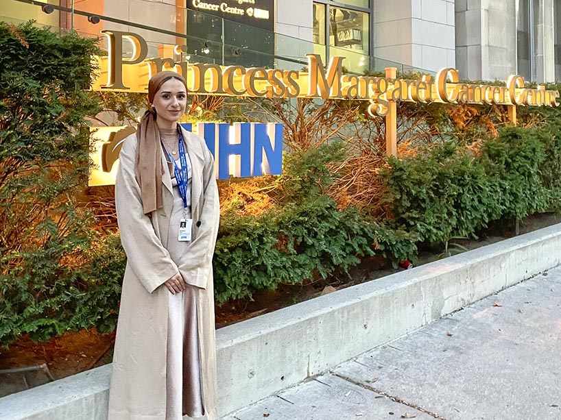 Marwah Azizi stands in front of Princess Margaret Cancer Centre.