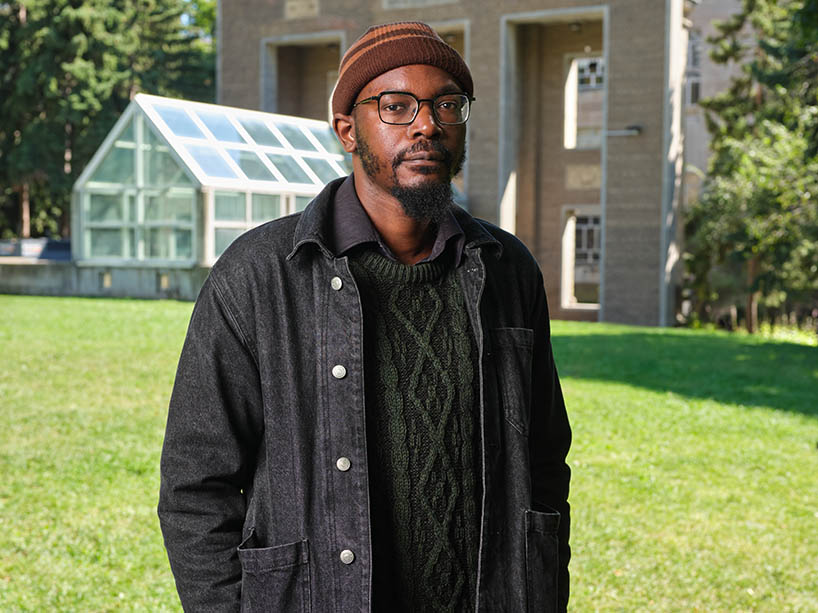 Victor Tubuseeke stands in the quad at TMU.