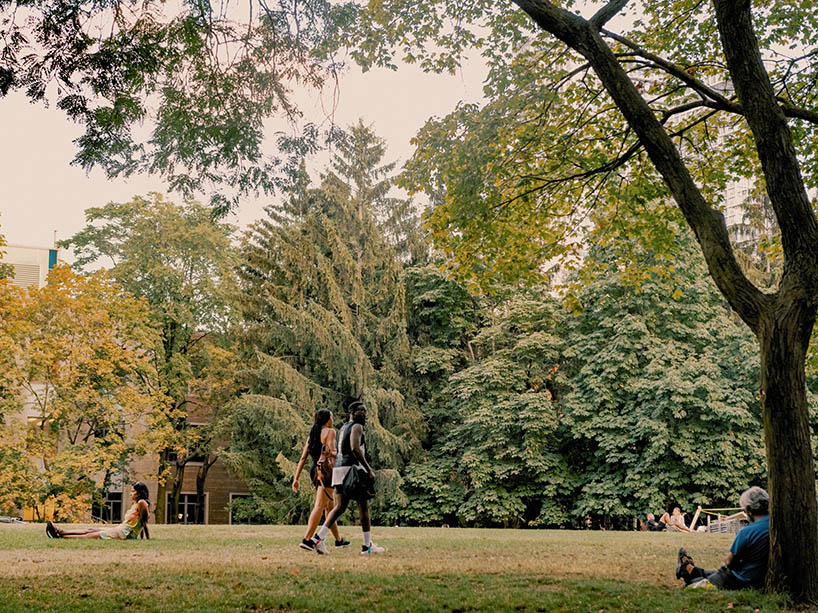 Students walking through the quad on a summer day.