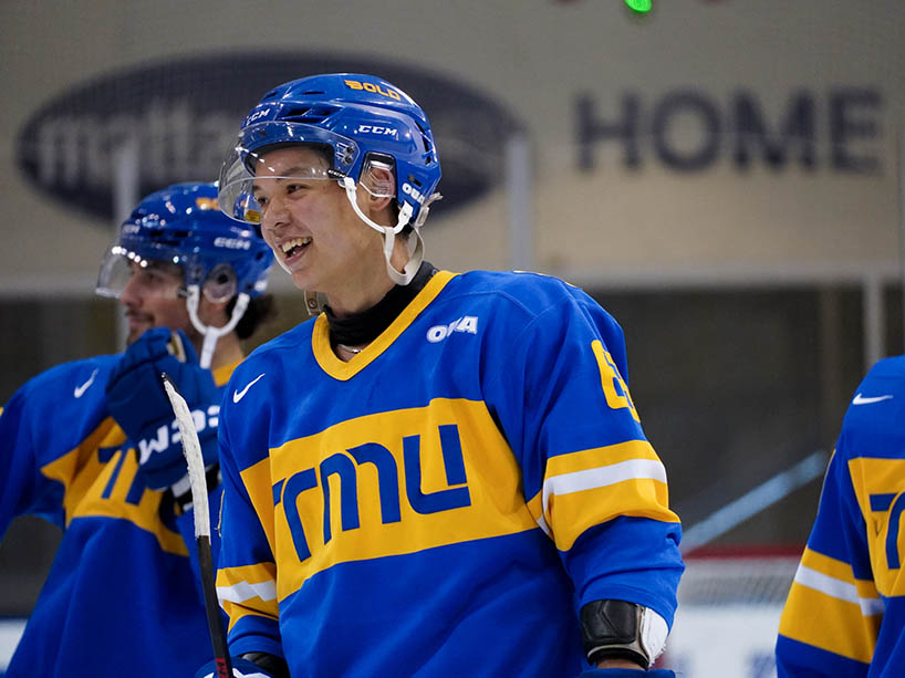 A hockey player smiles. 