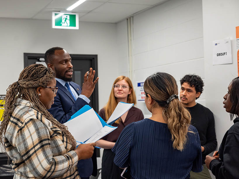 Jake Okechukwu Effoduh, professor of law, working with his students. 