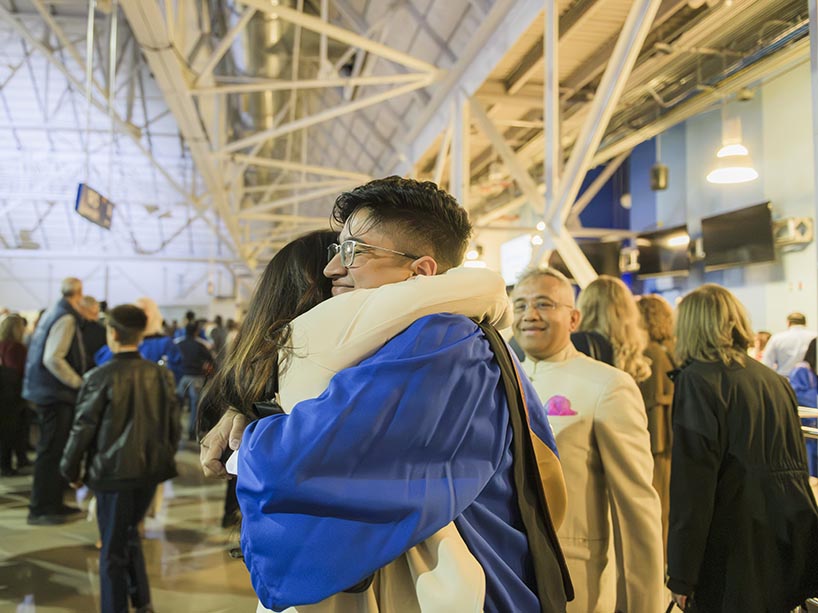 Two people hugging.