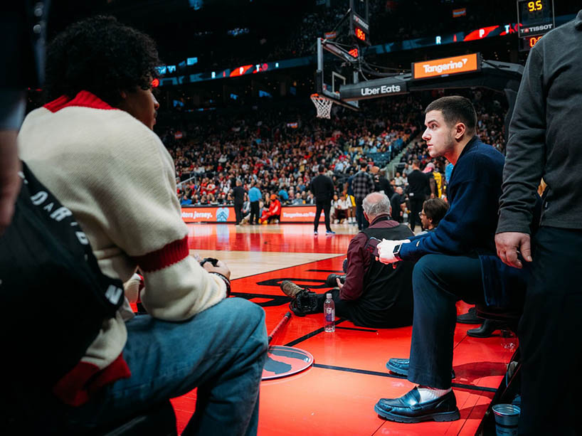 Émile Riga is pictured courtside at a Toronto Raptors game.